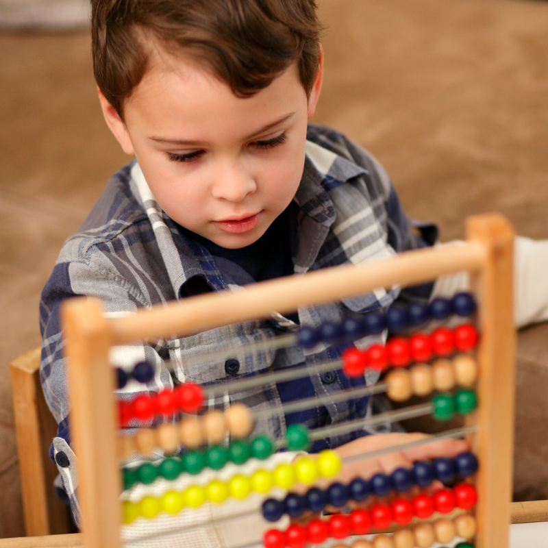 Tax-free childcare? Child counting on abacus